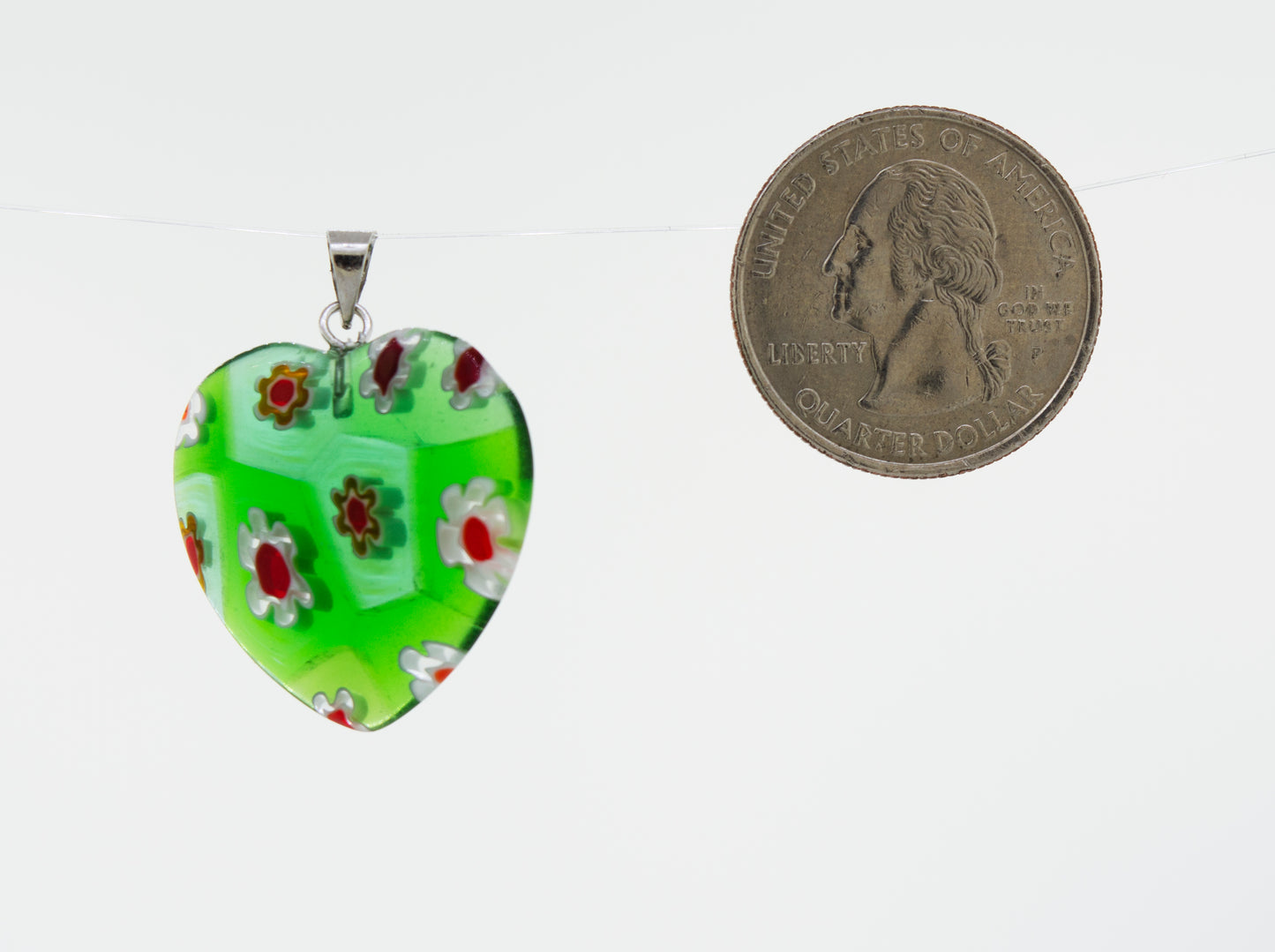 
                  
                    A green, translucent resin heart pendant with a Super Silver Heart Pendant with Flower Pattern embedded.
                  
                