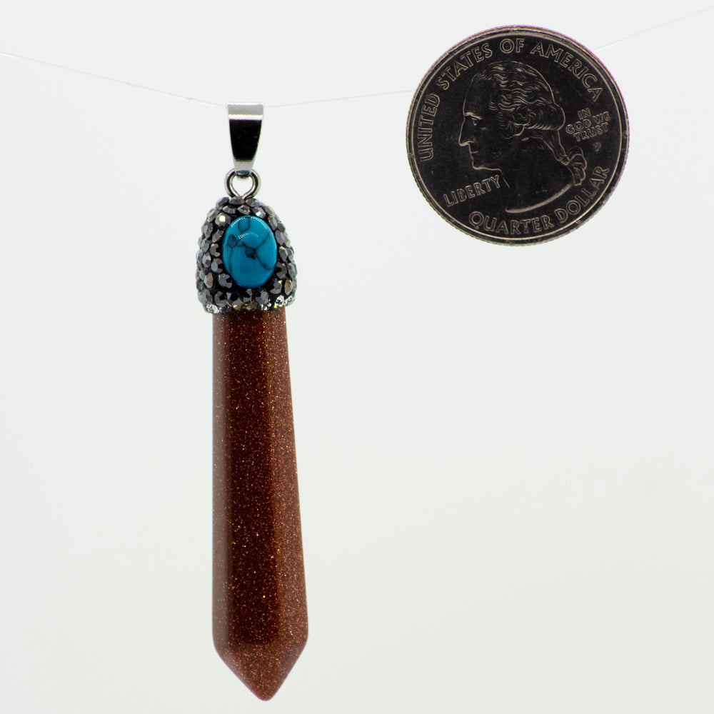 
                  
                    A Super Silver Stone Obelisk Pendant with a turquoise stone and an obelisk-shaped crystal next to it.
                  
                