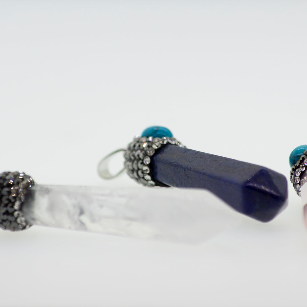 
                  
                    Super Silver stone obelisk pendants with turquoise stone accents.
                  
                