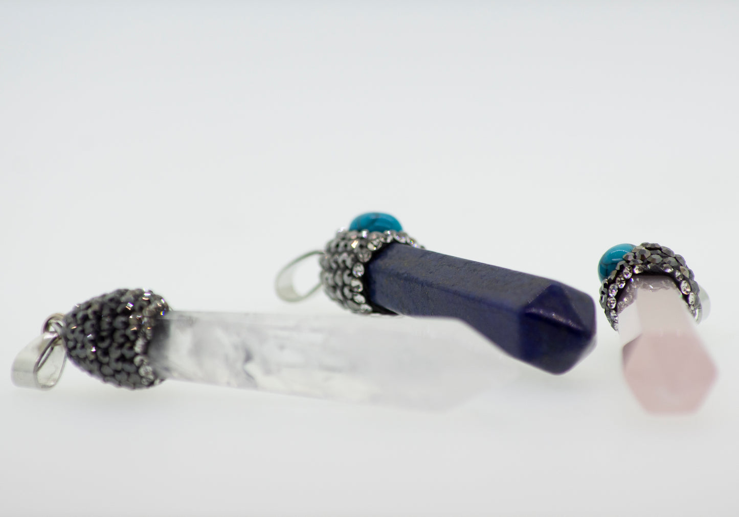 
                  
                    Super Silver stone obelisk pendants with turquoise stone accents.
                  
                