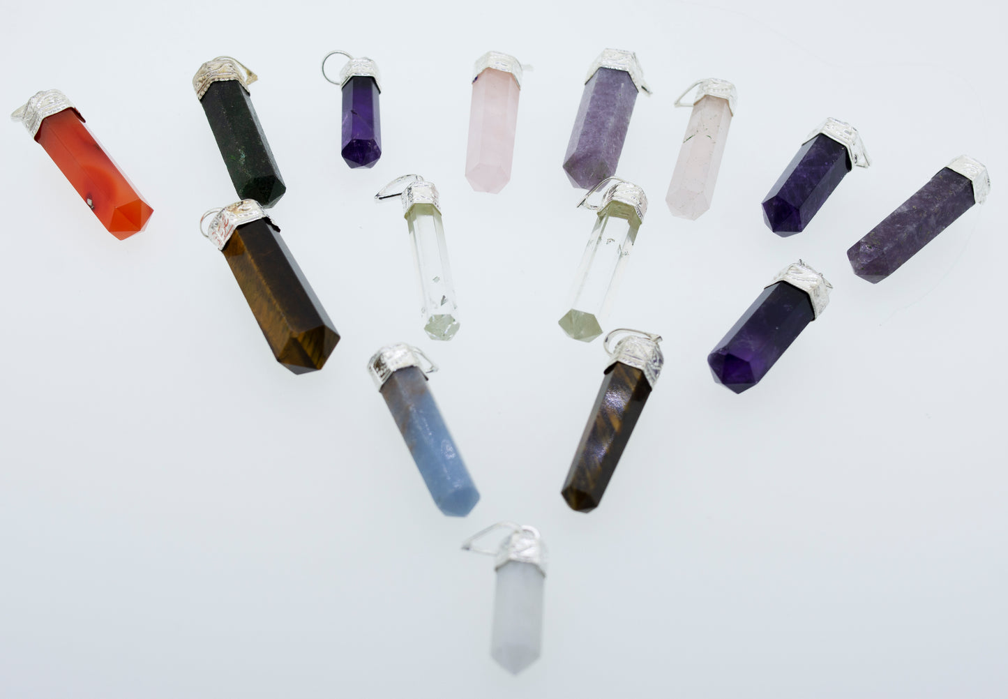 
                  
                    A circle of stones with different colored crystals layered in a Super Silver Raw Stone Obelisk Pendant design.
                  
                