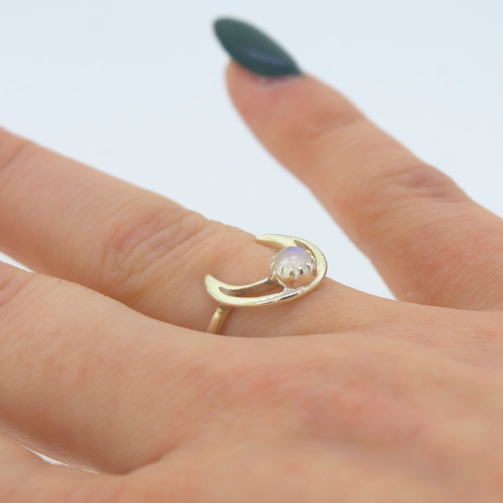 
                  
                    A woman's hand adorned with an elegant Super Silver Online Exclusive Moon Design Ring With Moonstone.
                  
                