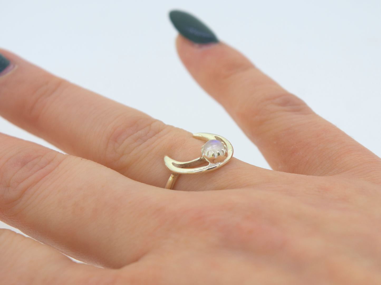 
                  
                    A woman's hand adorned with an elegant Super Silver Online Exclusive Moon Design Ring With Moonstone.
                  
                