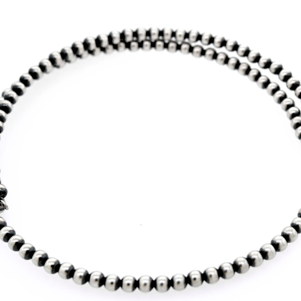 
                  
                    A Handcrafted Navajo Pearl Choker from Super Silver on a white background.
                  
                
