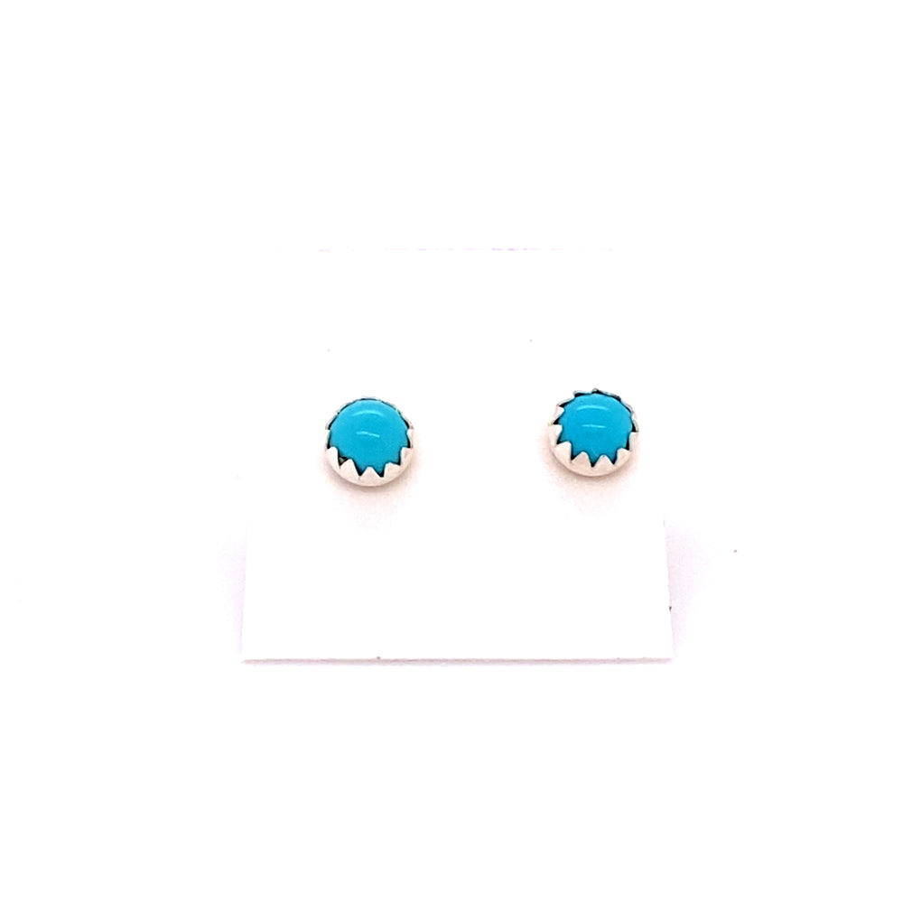 A pair of Super Silver turquoise stud earrings on a white background.