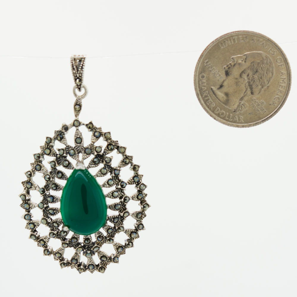 A Beautiful Aventurine Pendant with an emerald stone and a coin next to it by Super Silver.