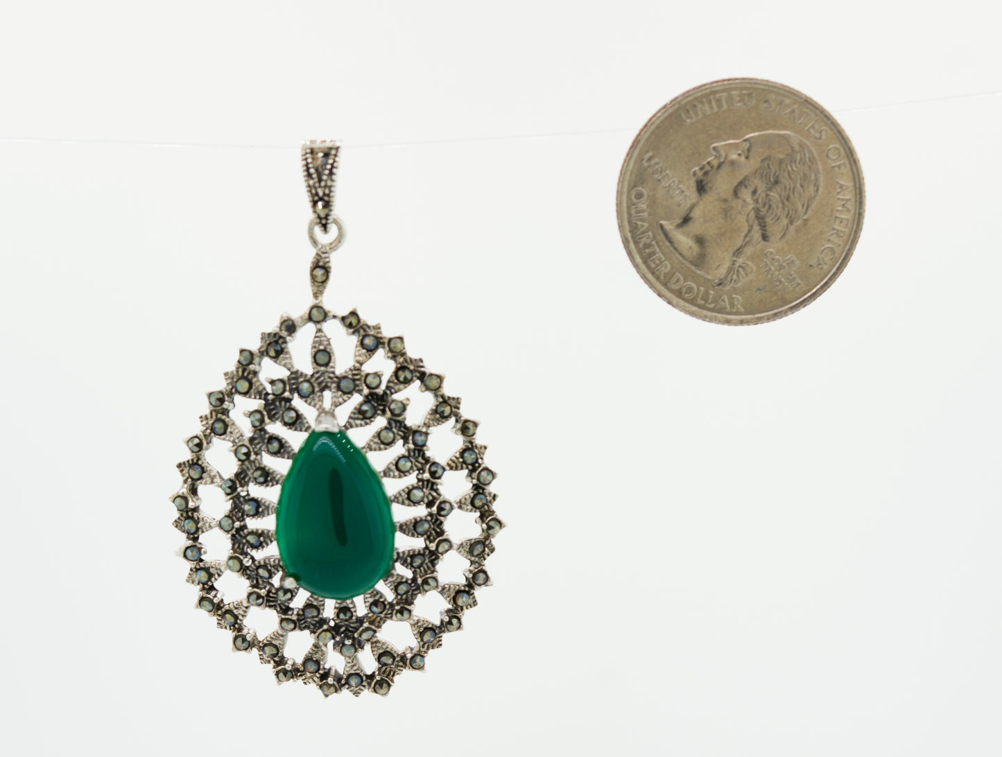 A Beautiful Aventurine Pendant with an emerald stone and a coin next to it by Super Silver.