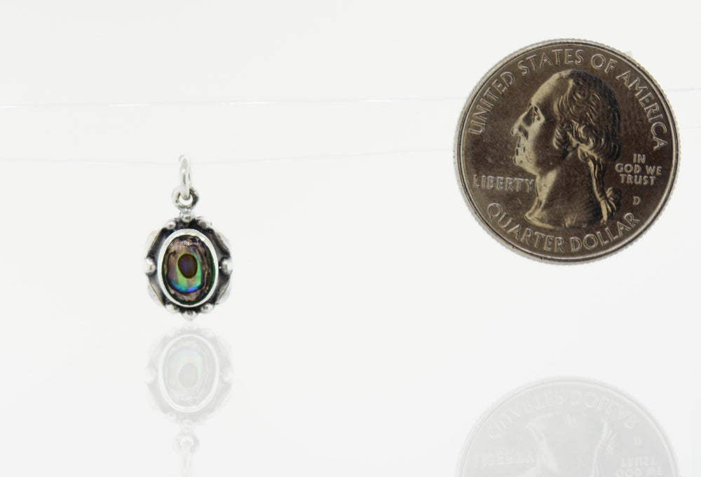 A small Super Silver pendant with a Beautiful Oval Stone Pendant With Silver Border next to it.