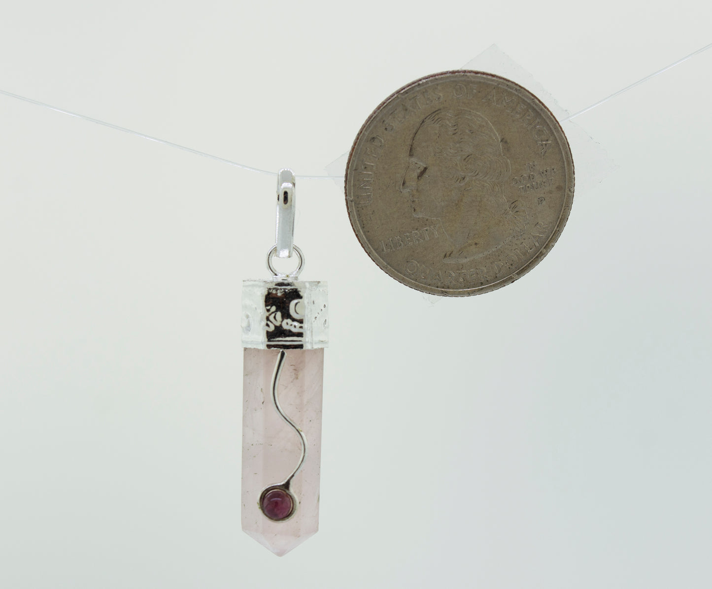 
                  
                    A Crystal Pendant with Decorative Bail by Super Silver, with a silver chain.
                  
                