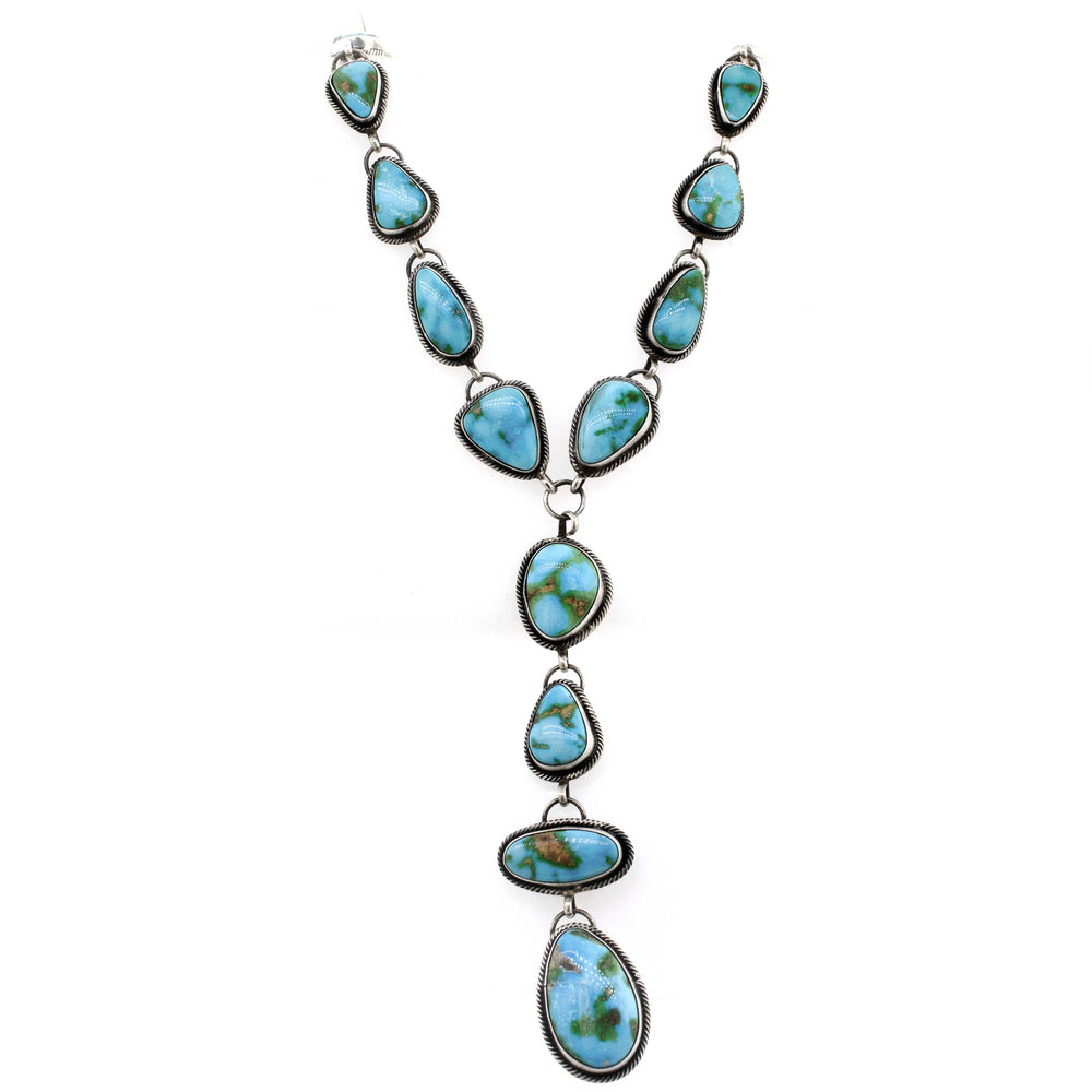
                  
                    A Stunning Sonora Gold Lariat Necklace And Earrings Set by Super Silver, with Sonora gold turquoise stones on a white background.
                  
                