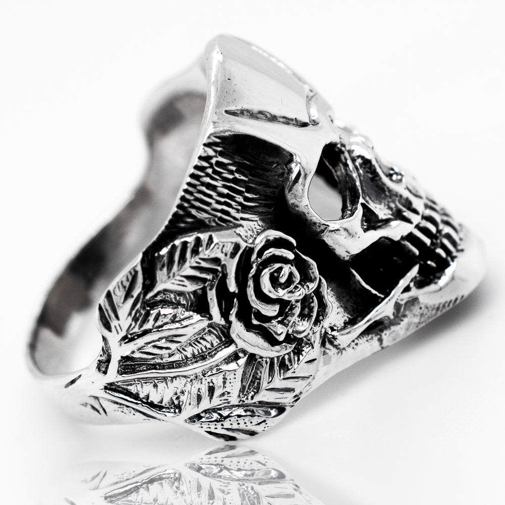 A Skull Ring With Rose Design statement ring, crafted with silver.