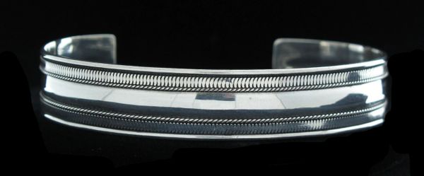 
                  
                    An everyday wear Super Silver Cuff Bracelet on a black background.
                  
                