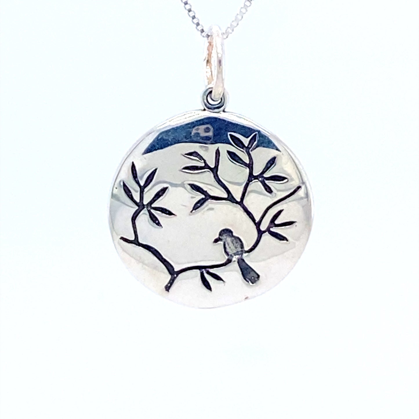 
                  
                    A Super Silver small circle nature charm with a bird on a cherry blossom branch.
                  
                