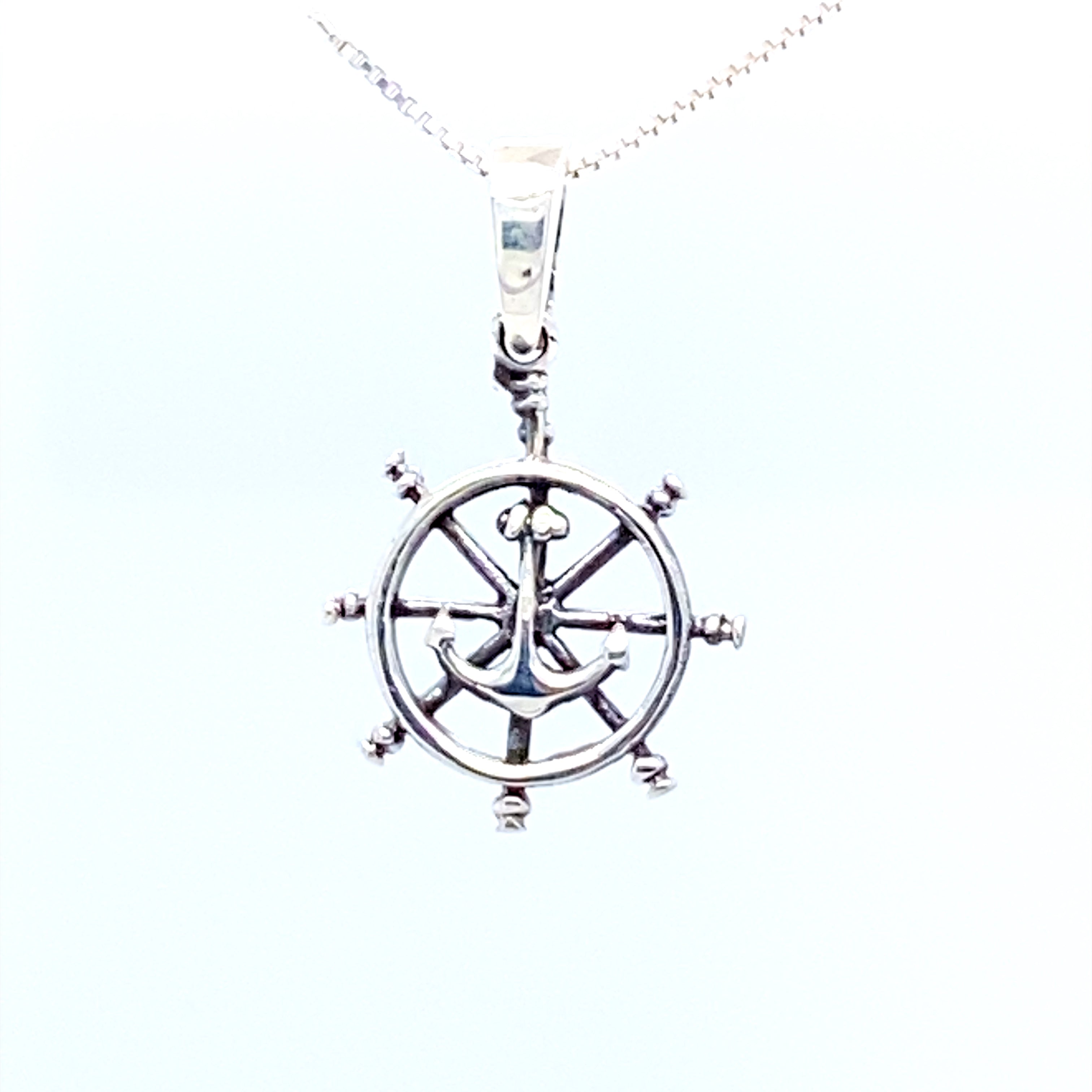 A Super Silver necklace featuring a Ships Wheel Charm with Anchor pendant, perfect for sea-fearing captains or those who love ocean-themed pendants.