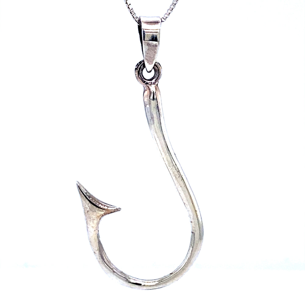 A Super Silver Fish Hook Pendant on a chain, symbolizing safe passage through the Polynesian triangle.