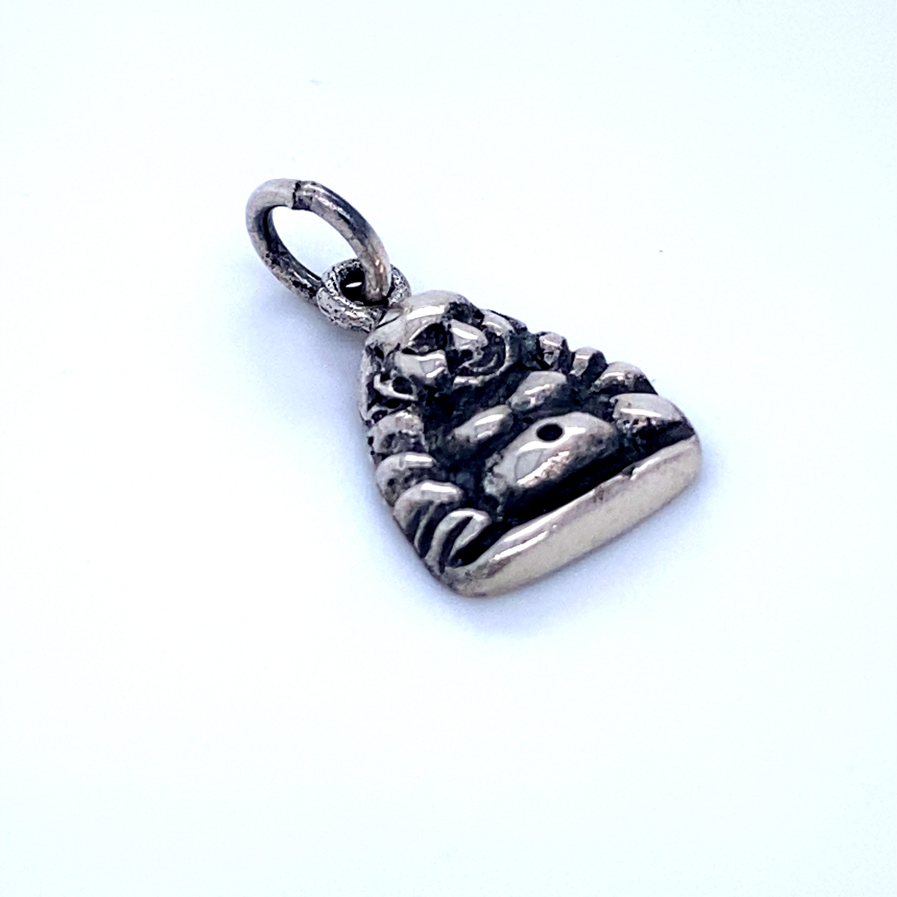 A Super Silver Laughing Buddha Charm pendant on a white surface.
