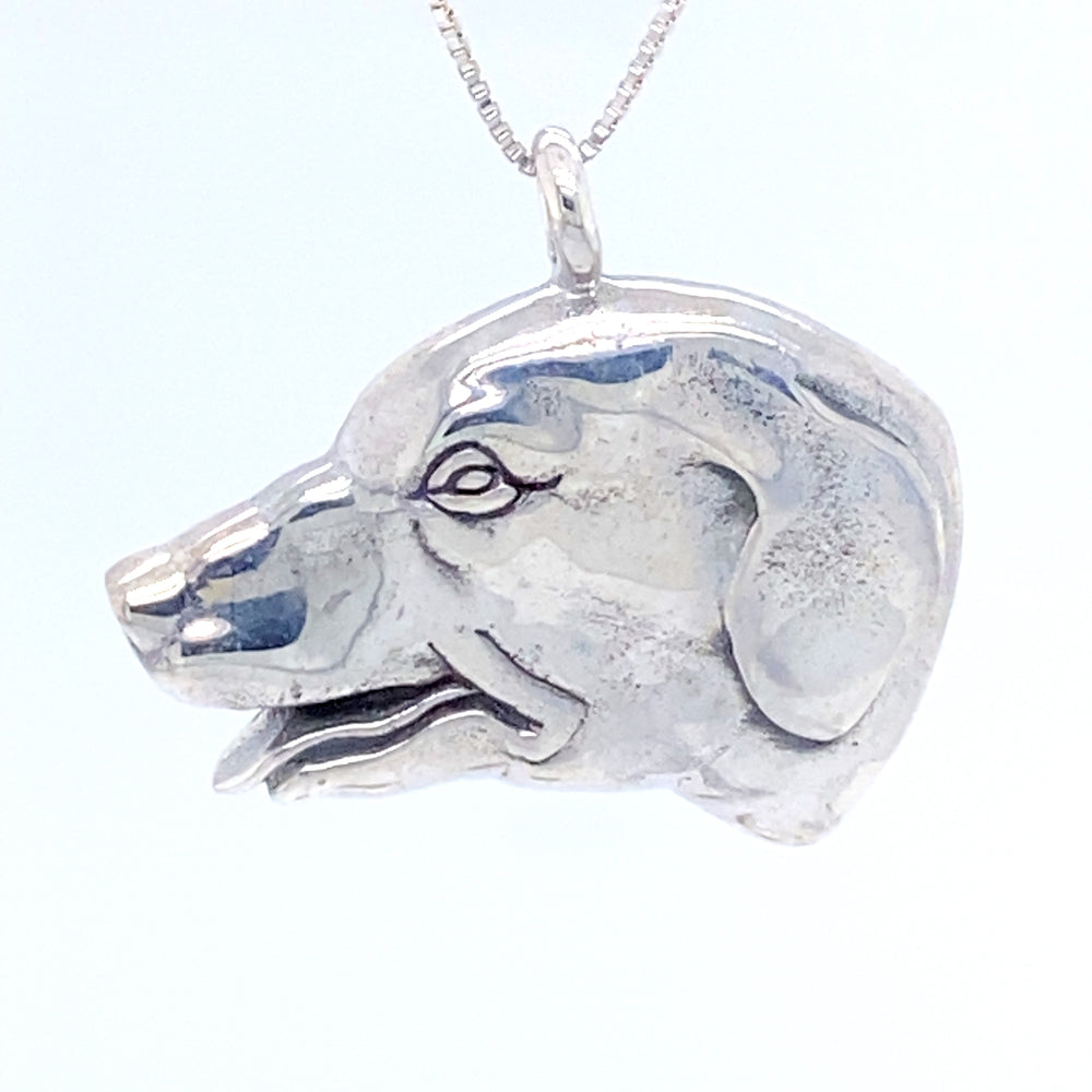 A Super Silver Dog Head Pendant on a chain, perfect for any dog lover.