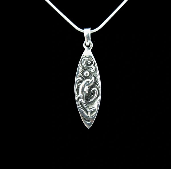 
                  
                    A Dolphin Surfboard Pendant with a celtic design on it made by Super Silver.
                  
                