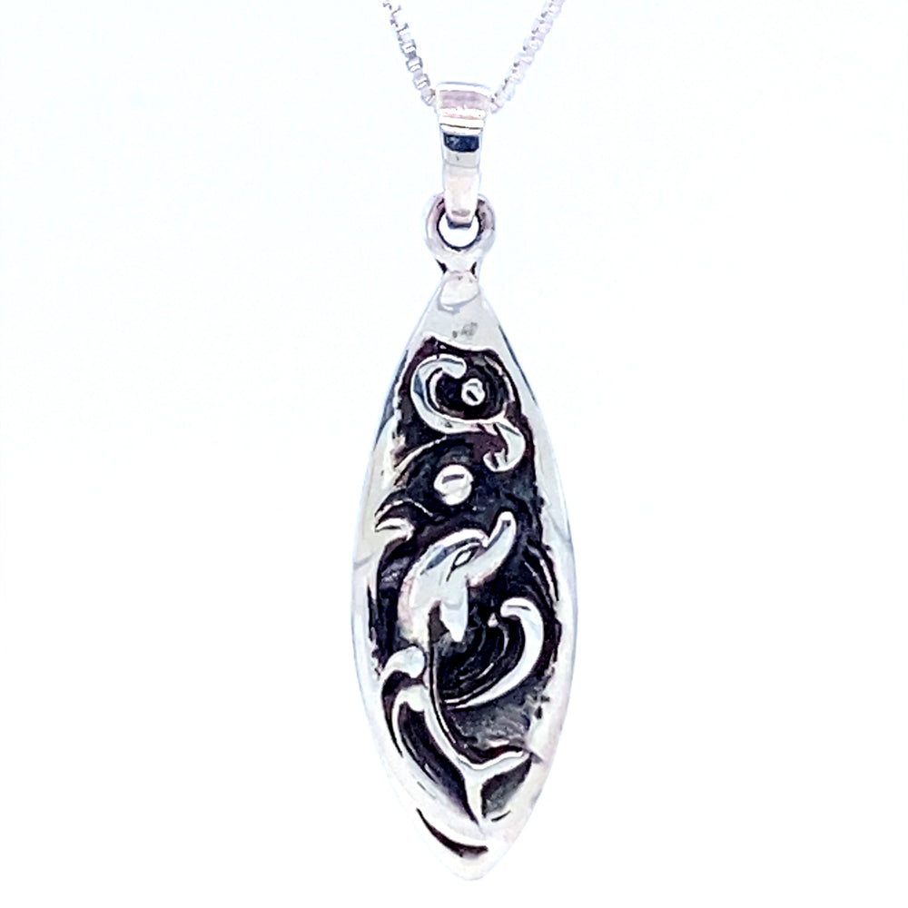 A Dolphin Surfboard Pendant with an abstract design inspired by the ocean found in Santa Cruz, made by Super Silver.