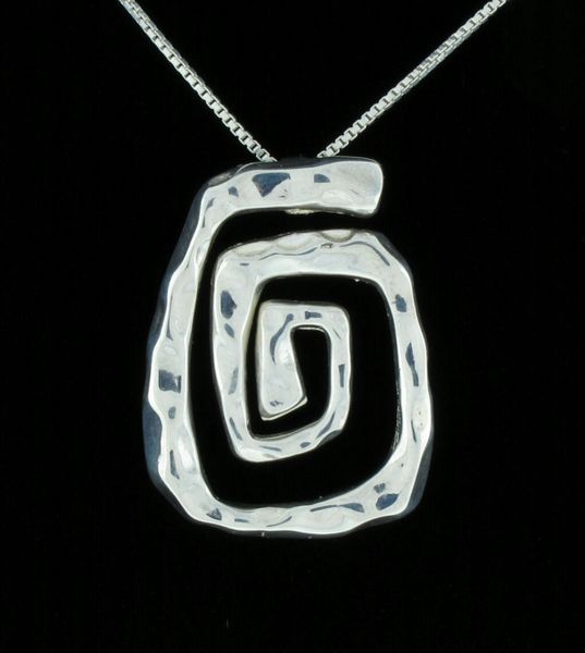 
                  
                    A Stunning Hammered Spiral Pendant by Super Silver on a black background.
                  
                
