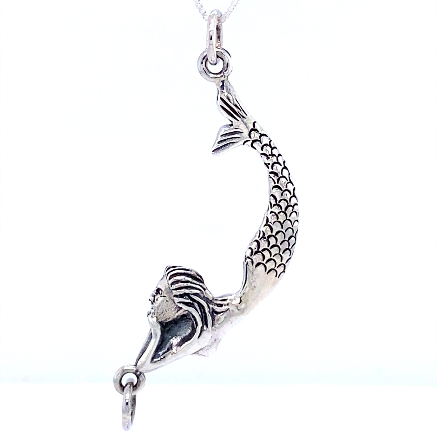 
                  
                    A Lounging Mermaid Pendant, resembling a sea goddess, gracefully hanging from a Super Silver necklace chain.
                  
                