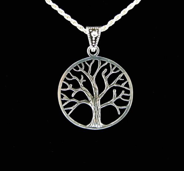 
                  
                    A Super Silver Mother Earth Tree Pendant on a black background.
                  
                
