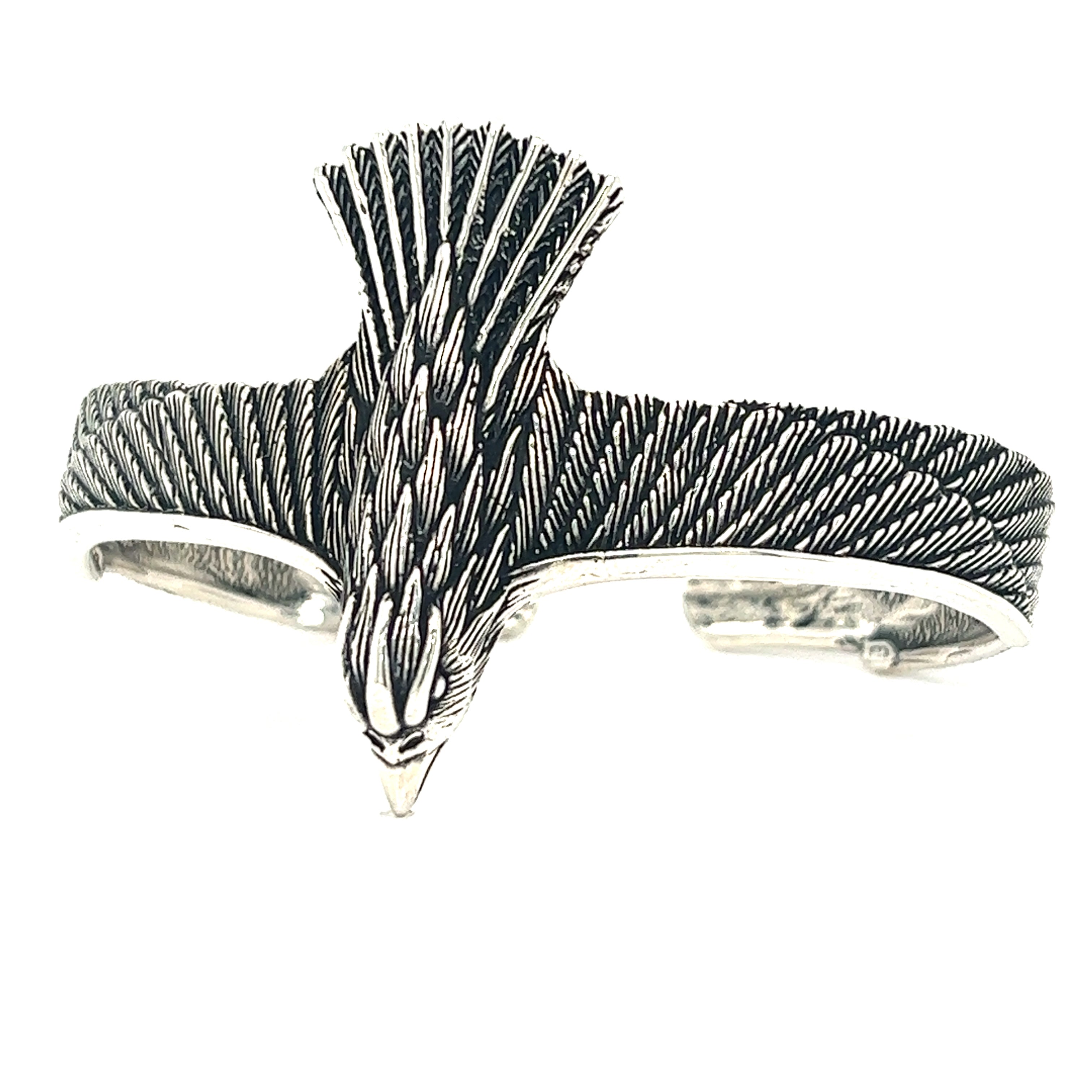 An oxidized Super Silver Unique Raven Cuff bracelet with an eagle on it, denoting symbolism.