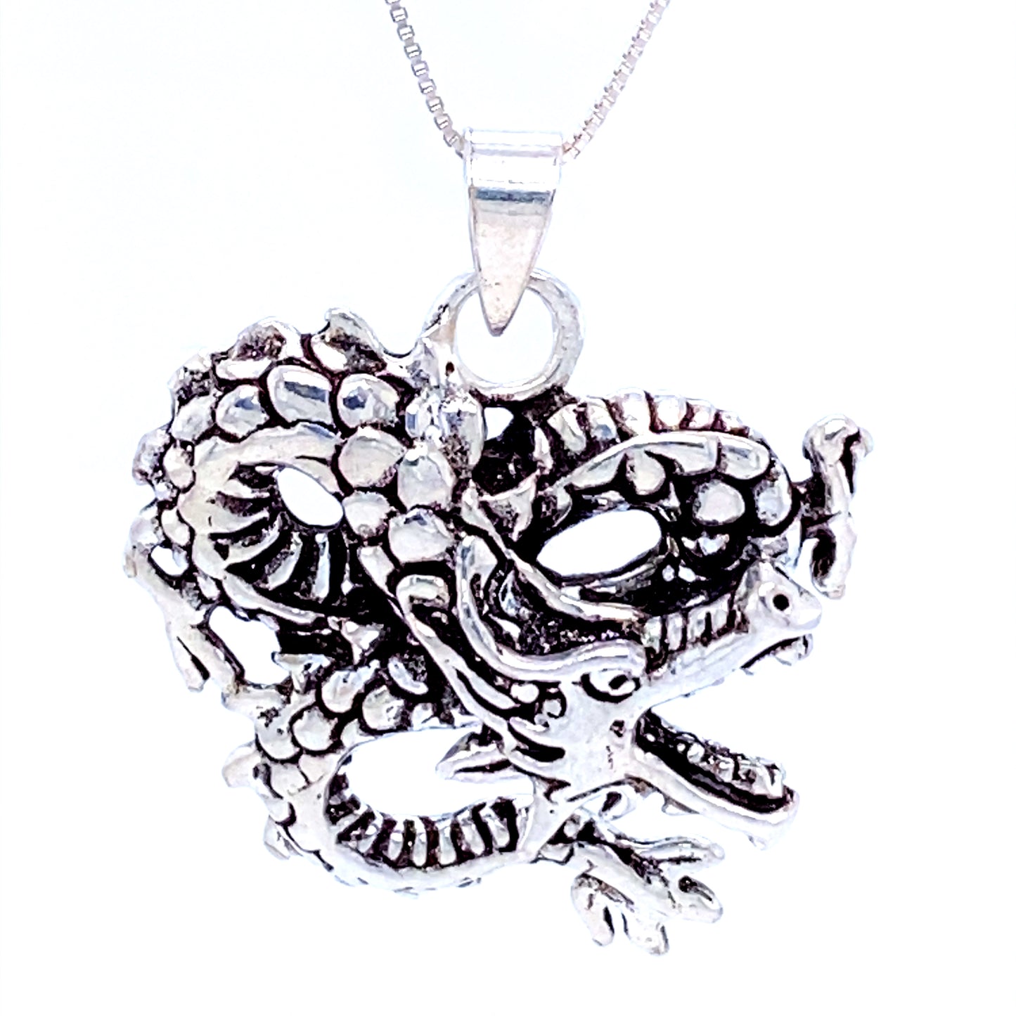 
                  
                    A Super Silver dragon pendant featuring fine details on a chain.
                  
                