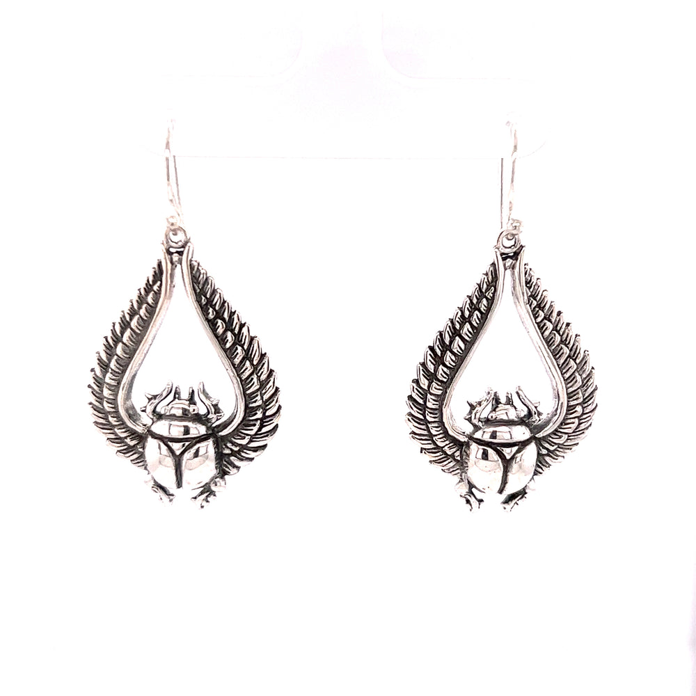 Super Silver's Winged Scarab Earrings featuring a winged scarab, providing protection.