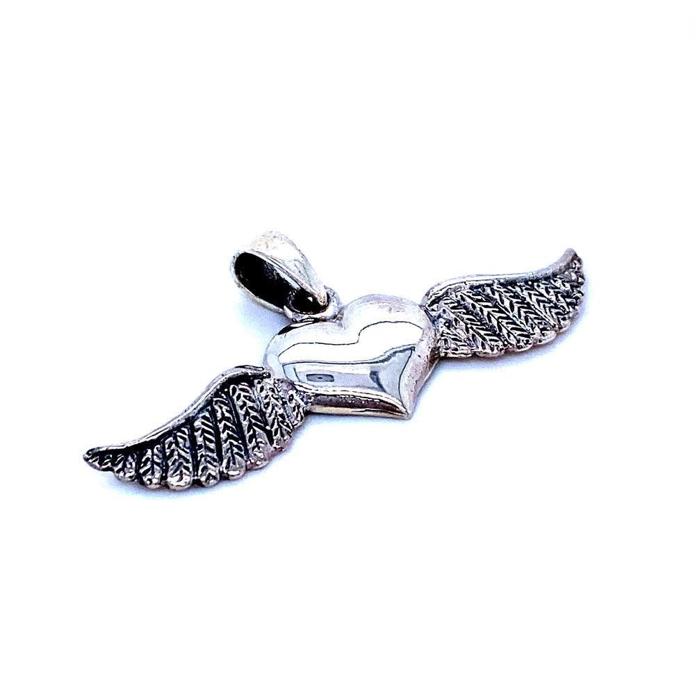 A Super Silver Heart With Wings Pendant, featuring an oxidized finish, on a white background.