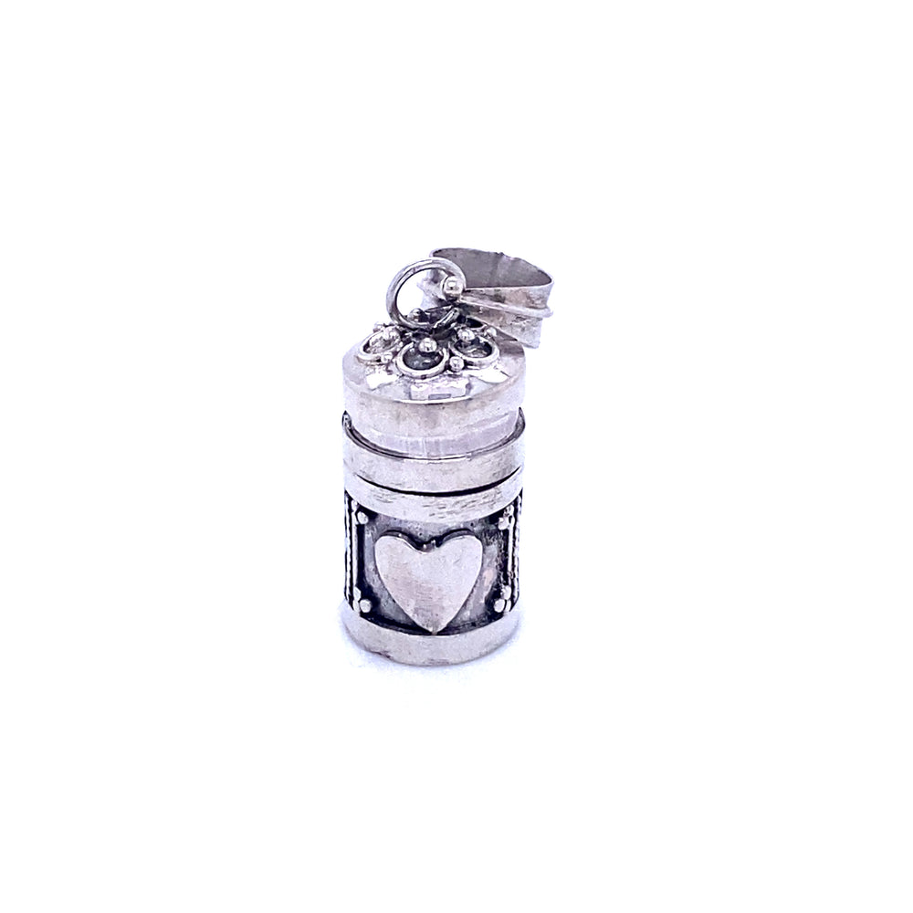 A Super Silver Prayer Box Pendant with a heart on it, perfect for holding religious scripture or sentimental mementos.