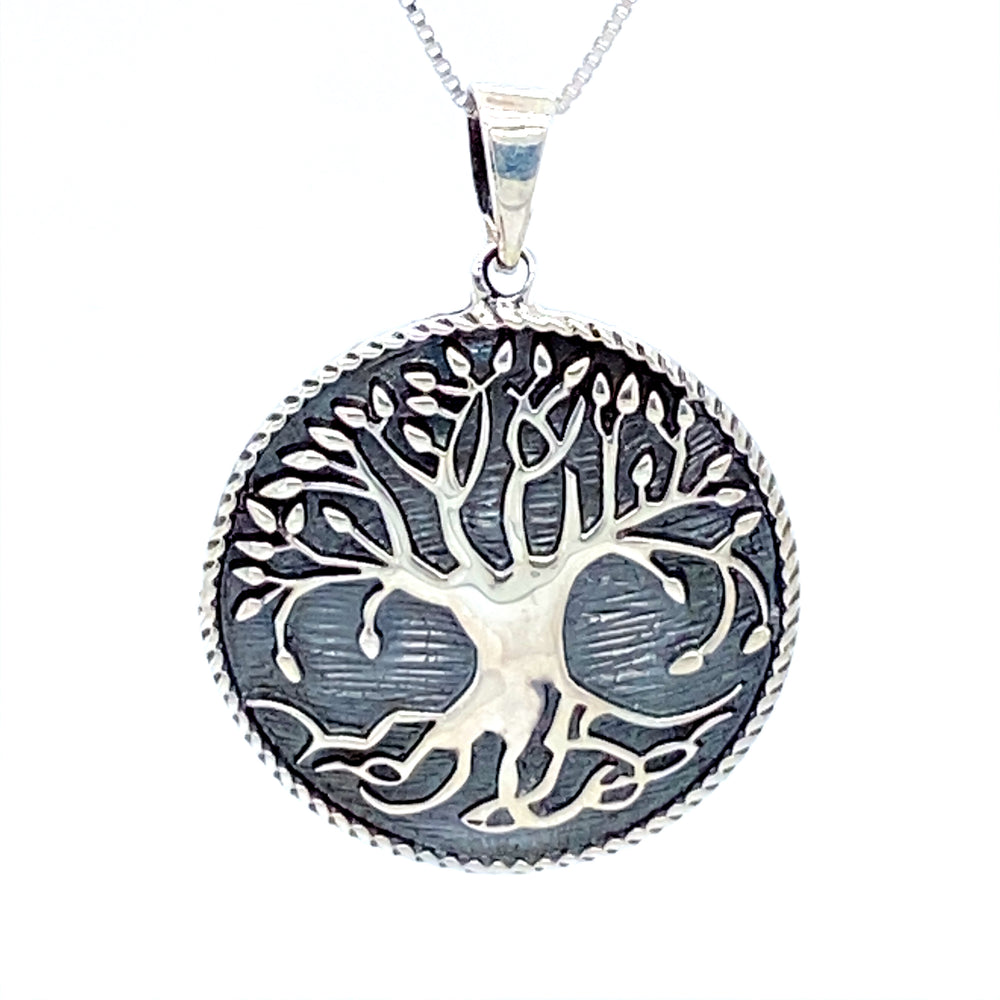 A stunning Enchanting Tree of Life Pendant by Super Silver, suspended on a delicate chain, perfect for any jewelry collection.