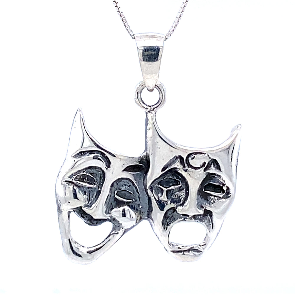 
                  
                    A Laugh Now Cry Later Pendant by Super Silver, featuring two theatre masks.
                  
                