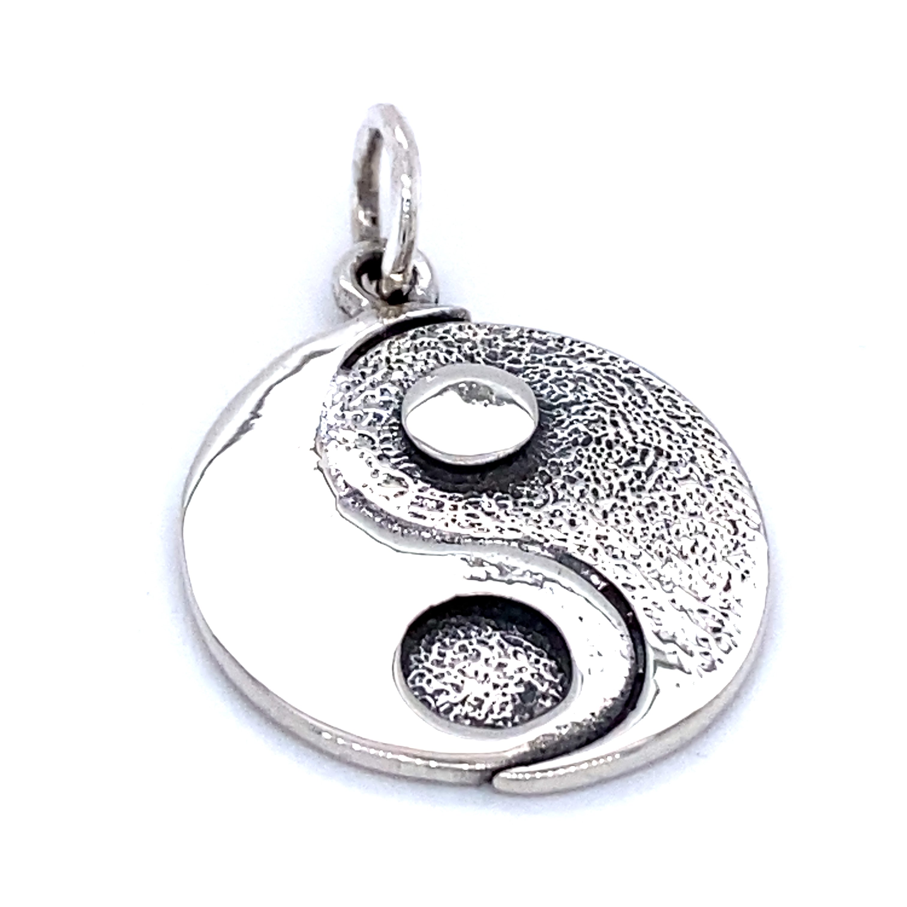 A Super Silver Yin Yang Pendant featuring a white yin - yang symbol.