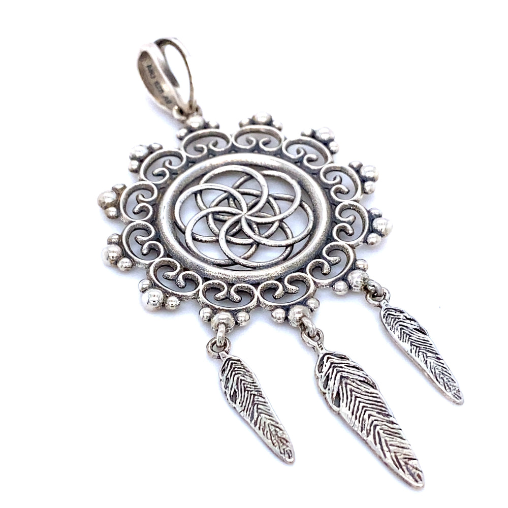
                  
                    A Flower of Life Mandala pendant by Super Silver with long feathers.
                  
                