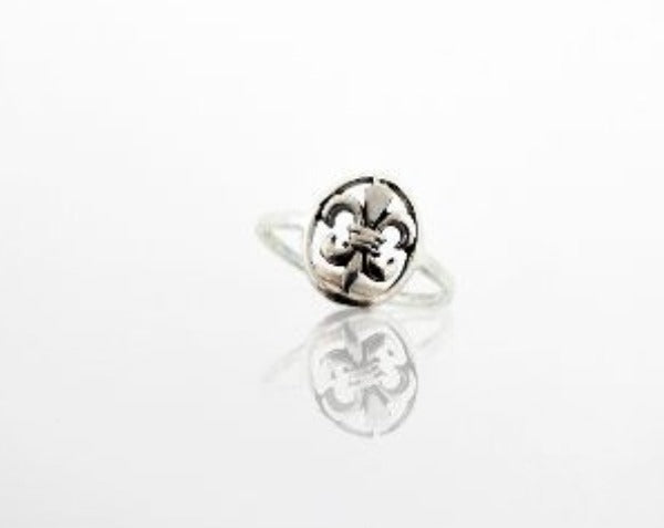 A Fleur De Lis Ring with a Super Silver flower on it.