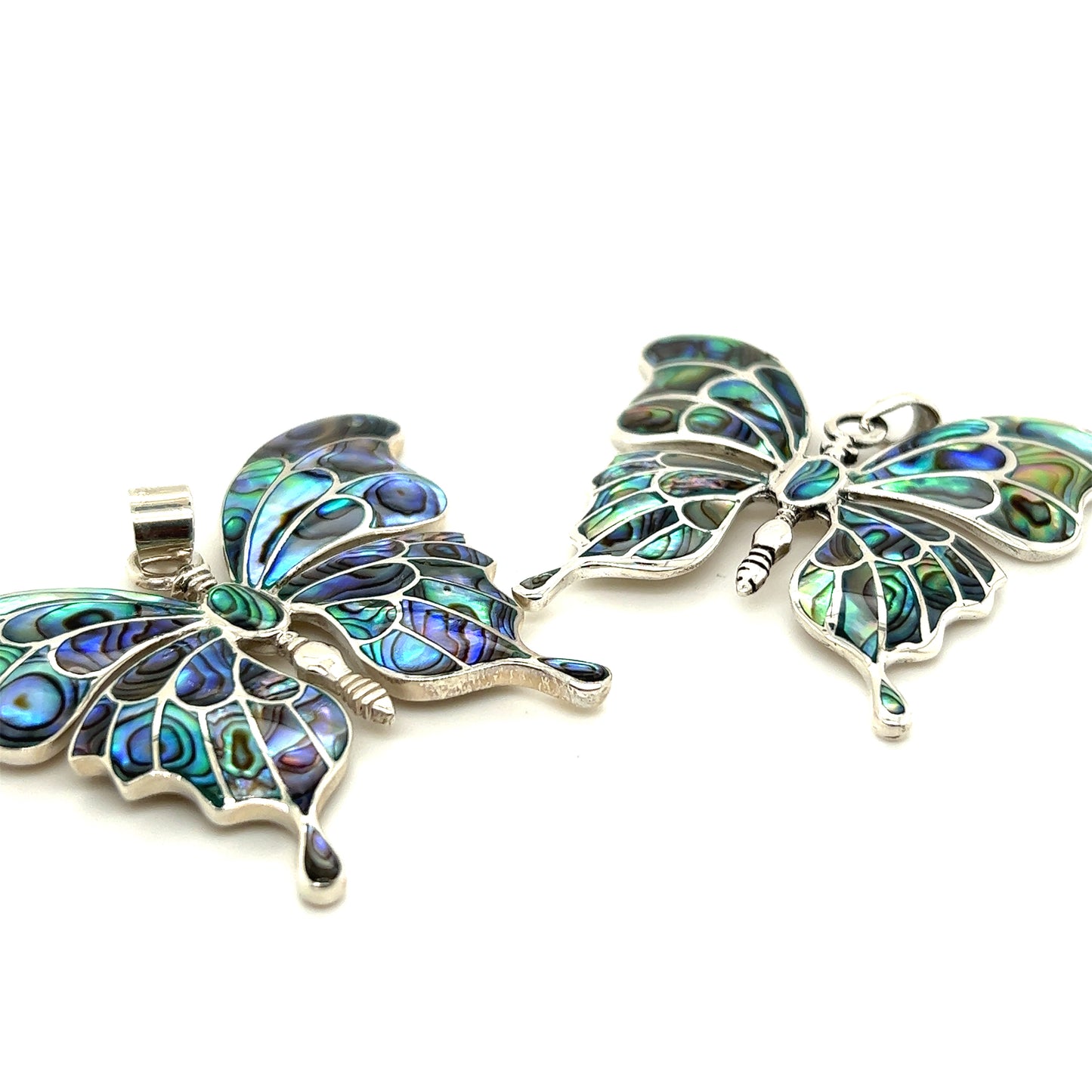 
                  
                    Two Super Silver Stunning Inlay Butterfly Pendants on a white surface.
                  
                