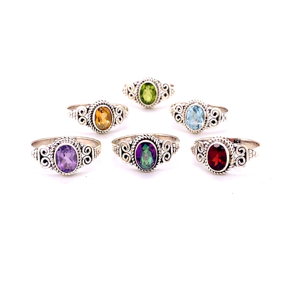 A set of Oval Faceted Gemstone Rings with a Swirl Design.