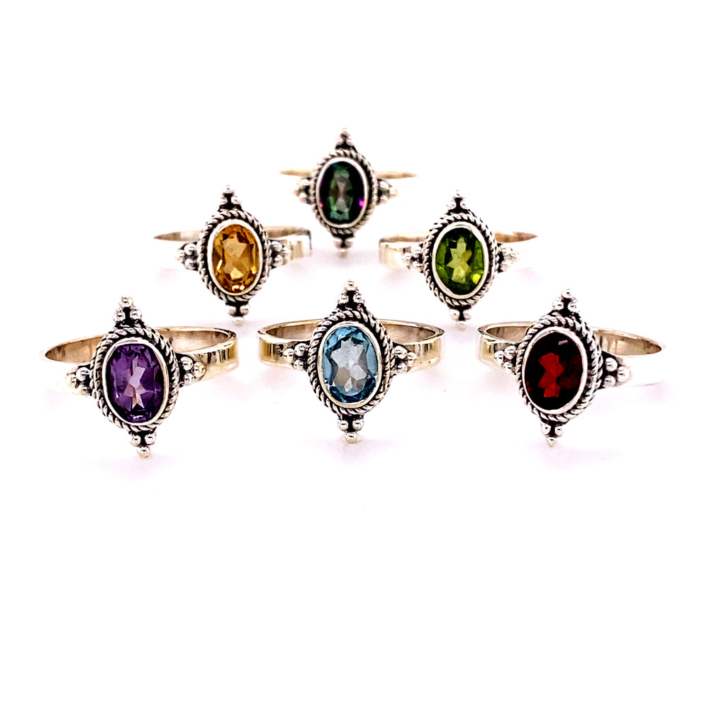 A set of Four Points Gemstone Rings with different colored cabochon stones.
