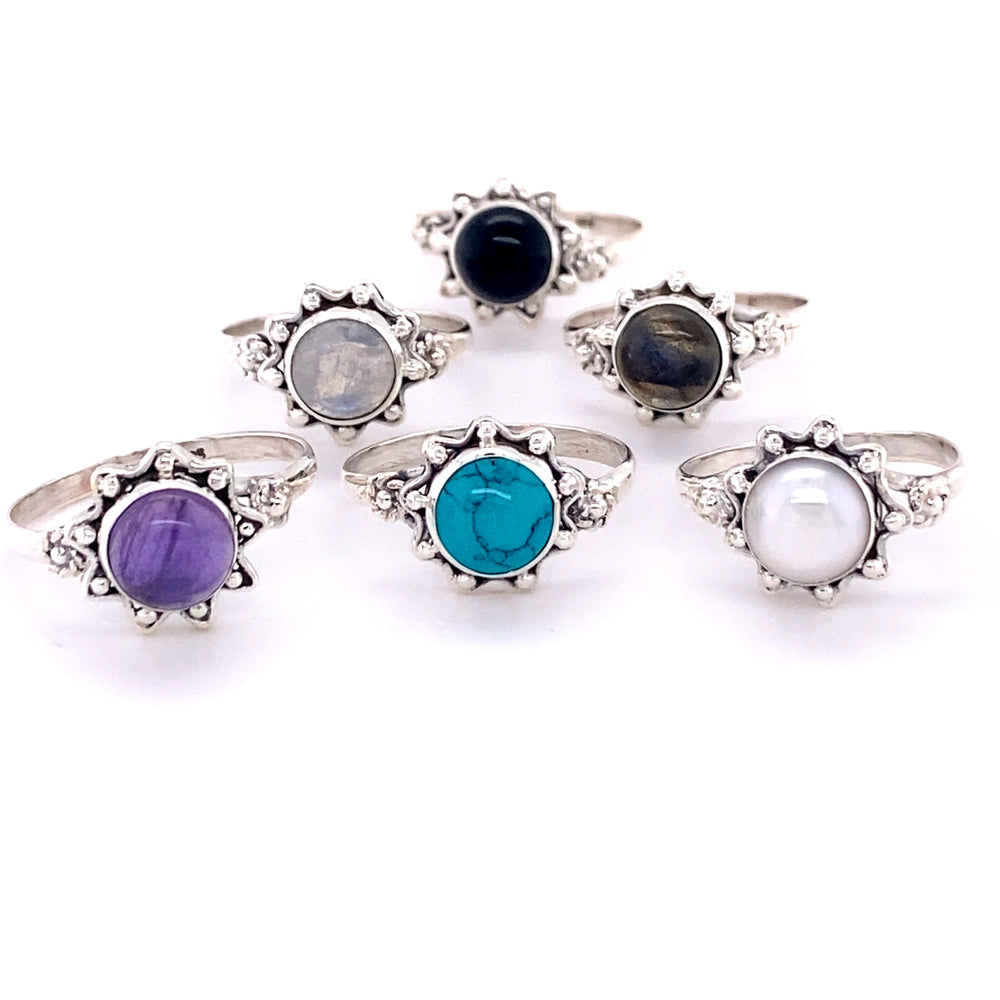 A collection of Flower Rings with Natural Round Gemstone stones adorned with vibrant cabochon stones.