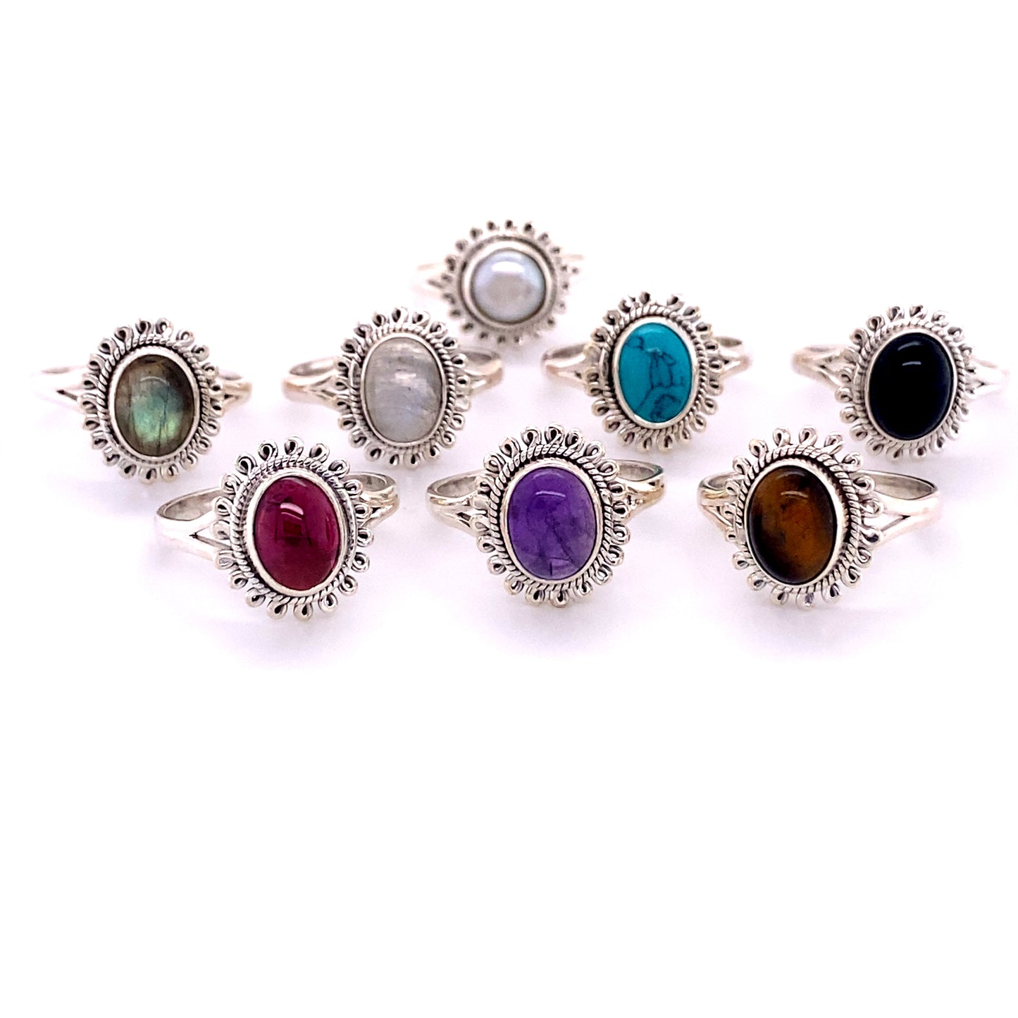 A Hippie-Chic Oval Gemstone Flower Ring-inspired set of sterling silver rings with different colored stones.