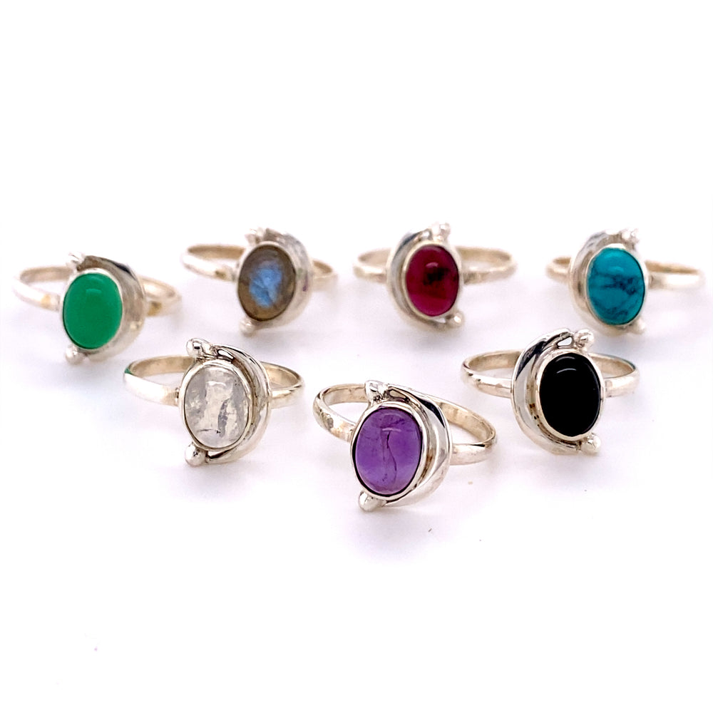 A group of Oval Crescent Moon rings with Natural Gemstones in different colors.