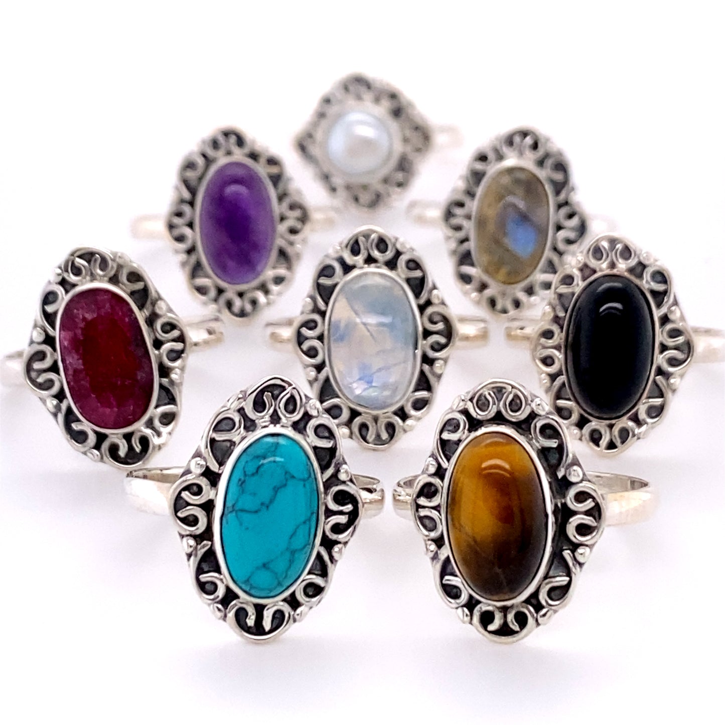A collection of Oval Gemstone Rings with Swirl Filigree Border.