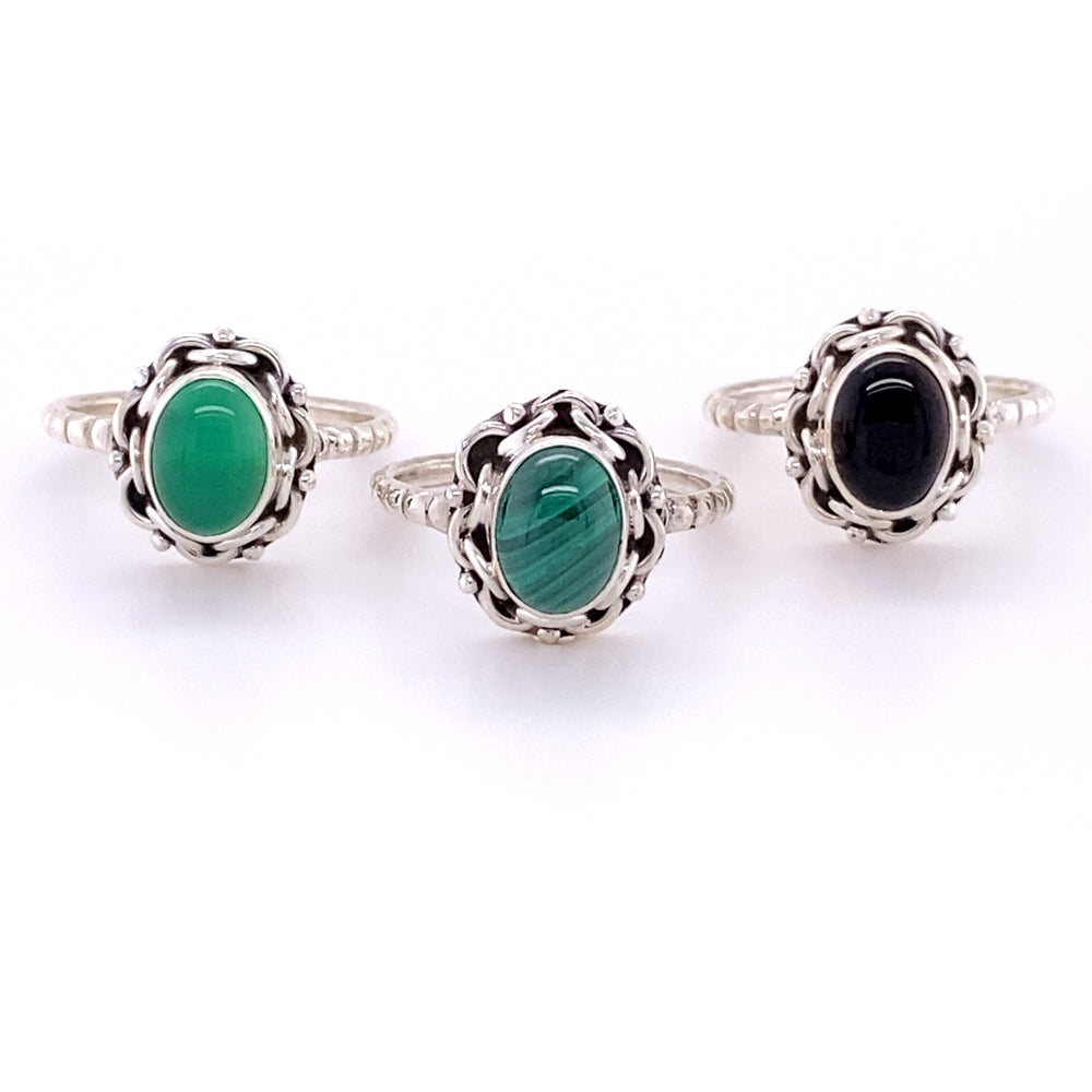 Three Natural Oval Gemstone Rings with Intricate chain Border and Textured Band.