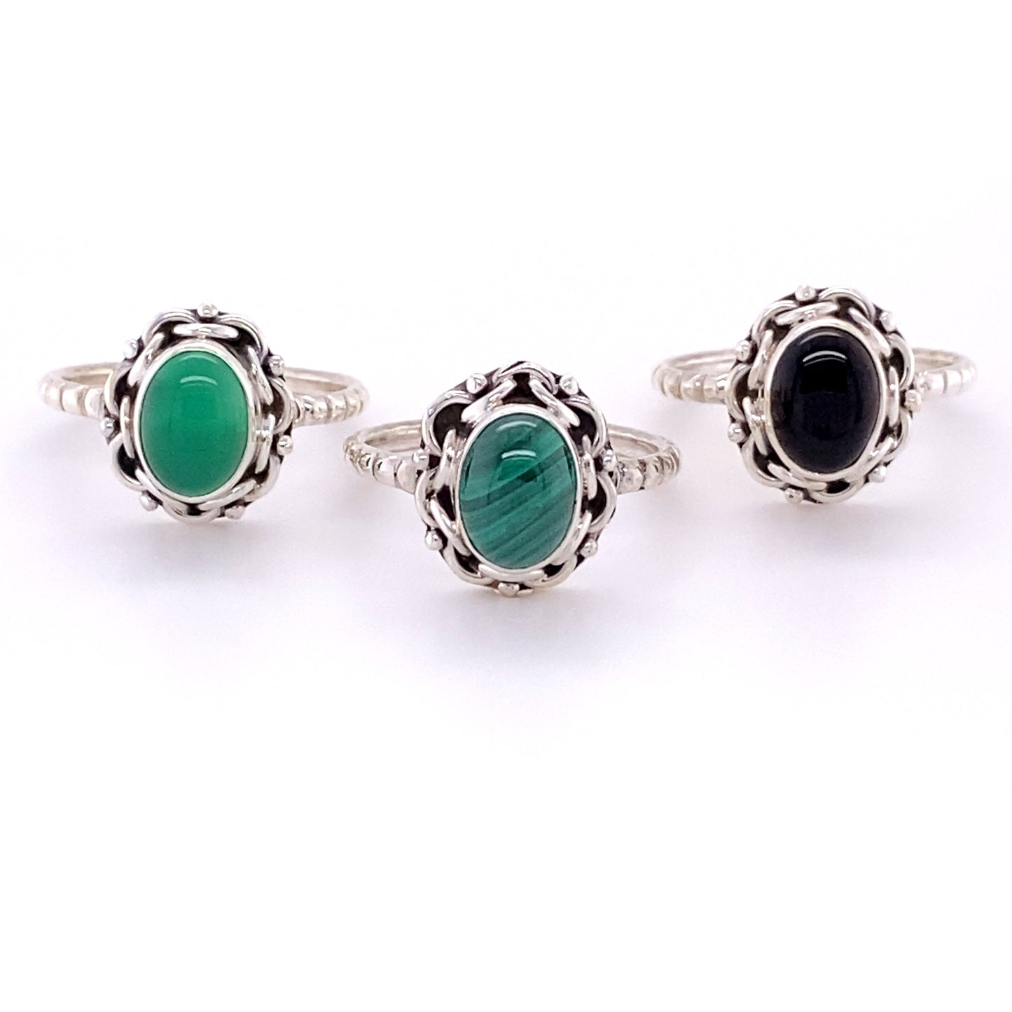Three Natural Oval Gemstone Rings with Intricate chain Border and Textured Band.
