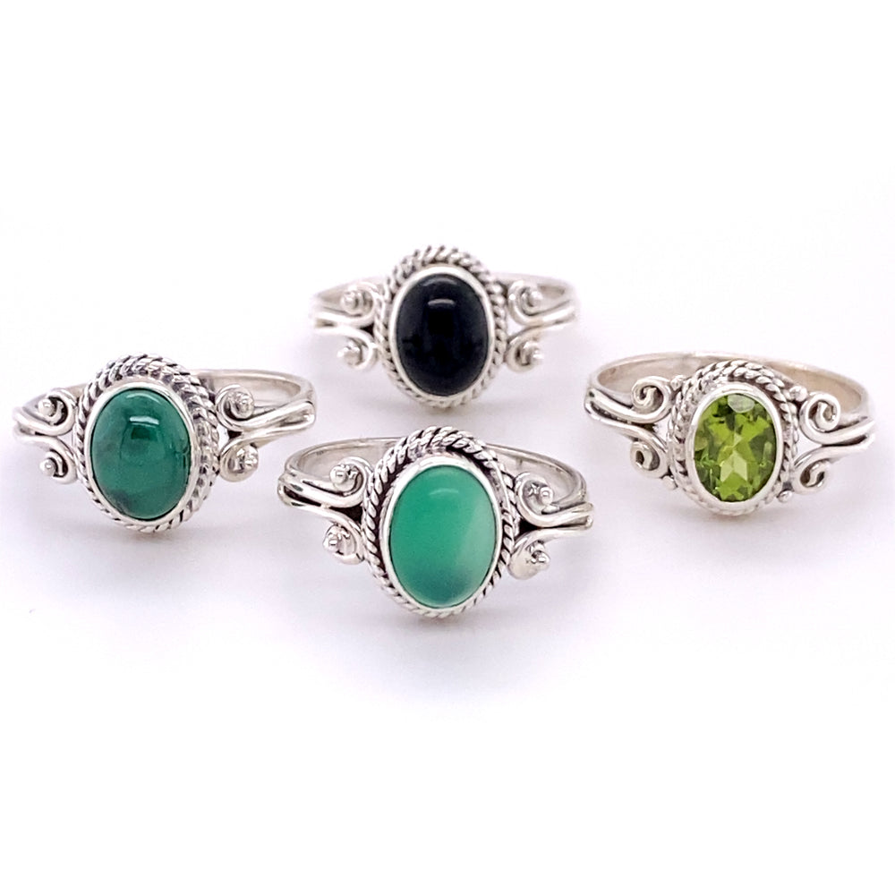 A set of Oval Natural Gemstone Rings with Rope and Long Spiral Border with green and black cabochon stones.