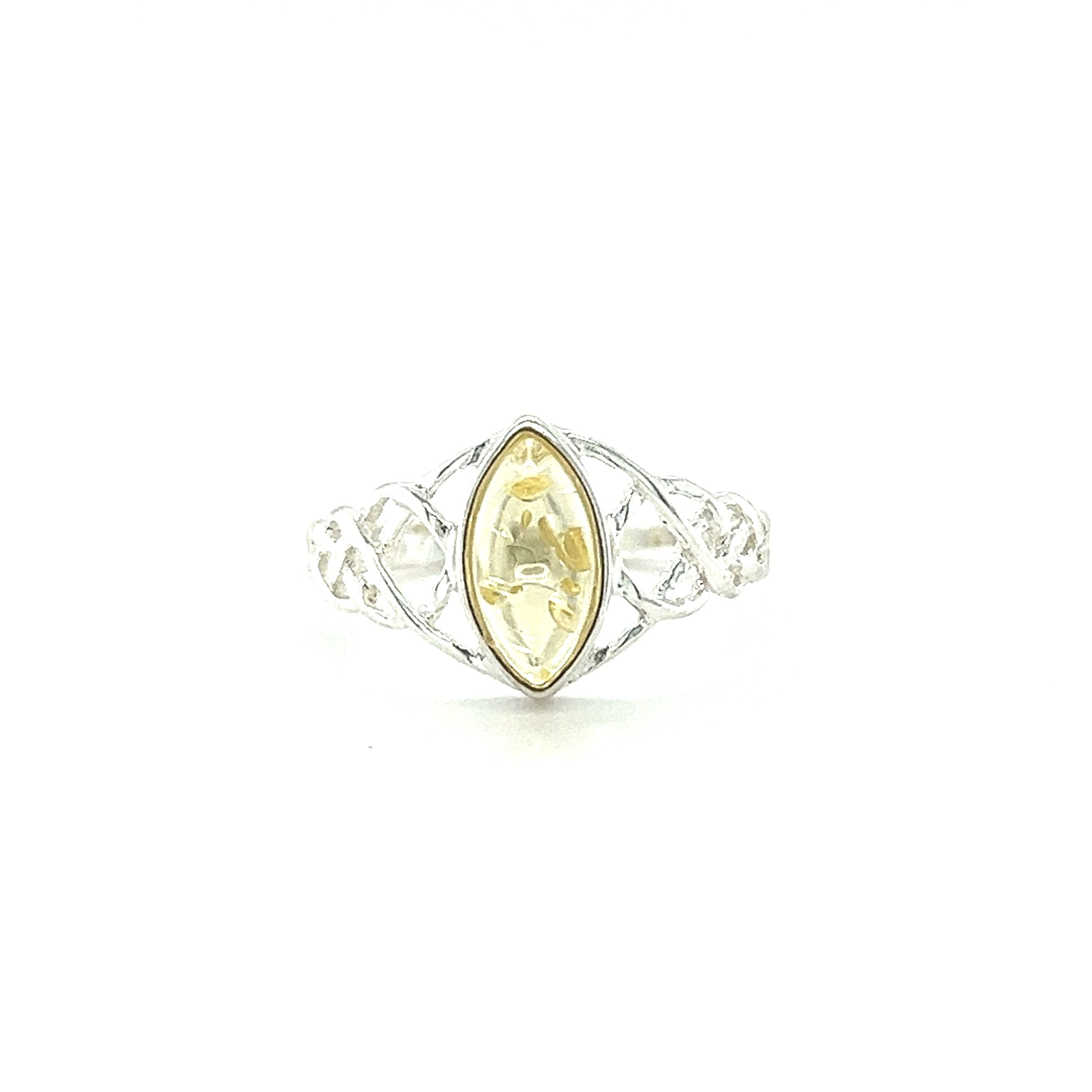 A Baltic Amber Marquise Shaped Celtic Style Ring with a glowing citrine stone from Super Silver.