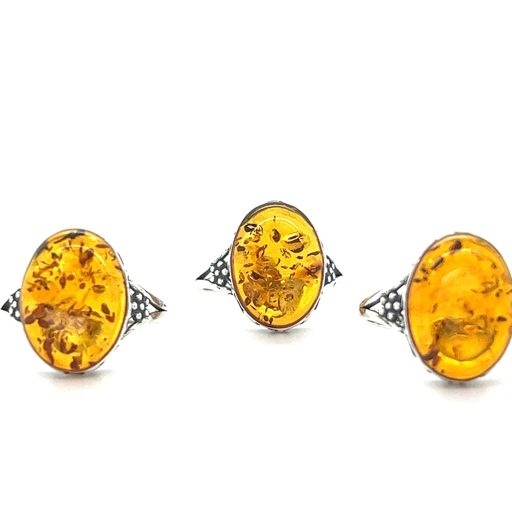 
                  
                    Three Super Silver boho chic rings made of Baltic Amber Ring with Victorian Styled Floral Setting.
                  
                