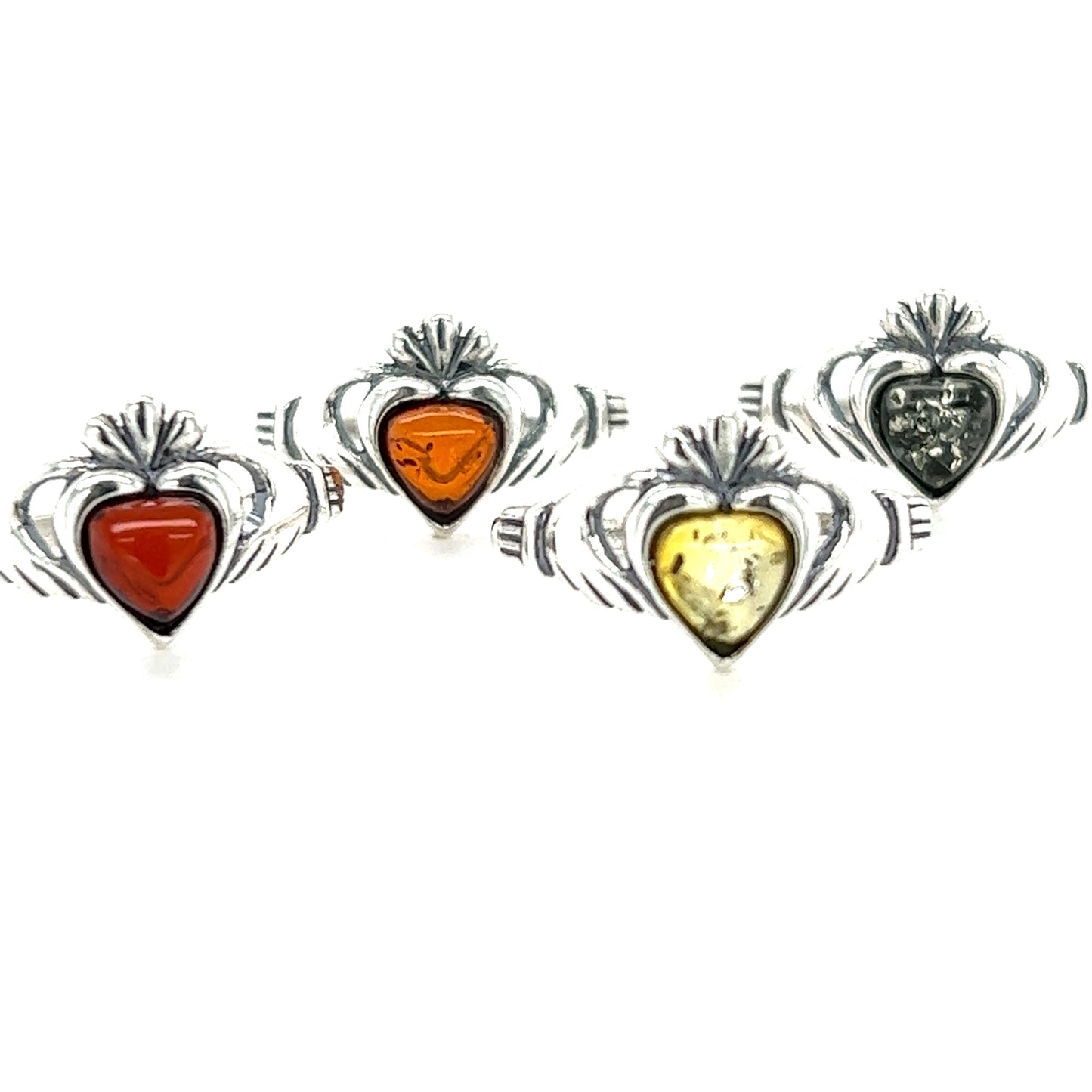 
                  
                    Four Claddagh Amber Heart Rings with red and orange stones. Made from .925 Sterling Silver, these rings feature Claddagh designs and are adorned with beautiful Baltic amber stones. They symbolize love and friendship. (Brand Name: Super Silver)
                  
                