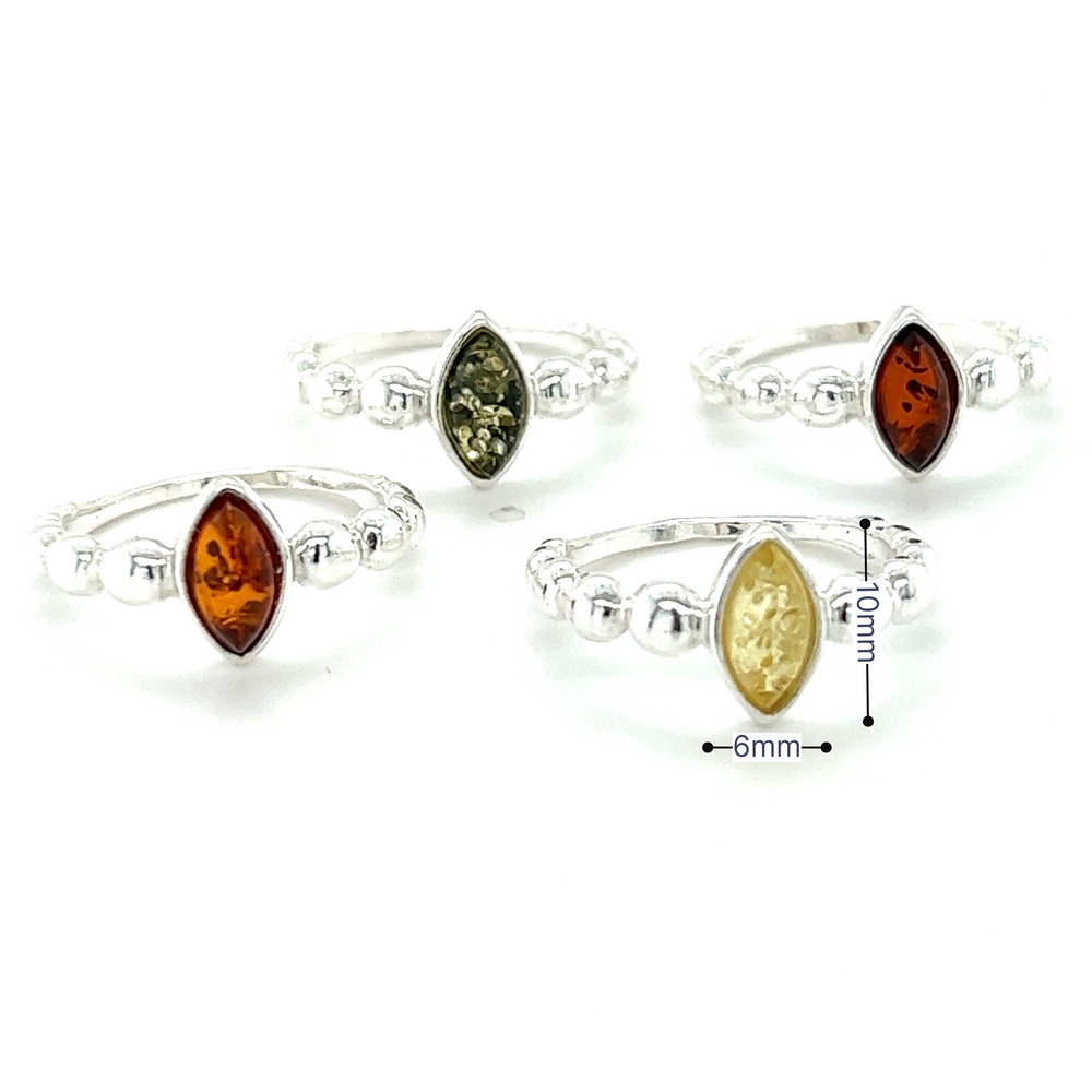 A set of four Modern Amber Rings with Half Beaded Band from Super Silver, made of .925 Sterling Silver with Baltic amber and yellow stones.